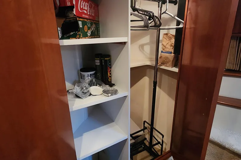 Slide: The Image of Storage area inside a 2005 Carver 466 Motor Yacht with shelves and hangers. - 20