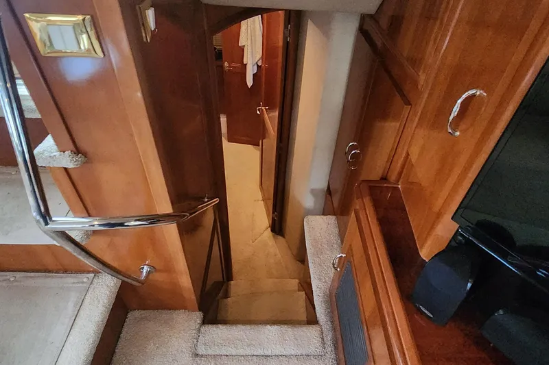 Slide: The Image of 2005 Carver 466 Motor Yacht interior with wooden stairs and elegant cabinetry. - 21