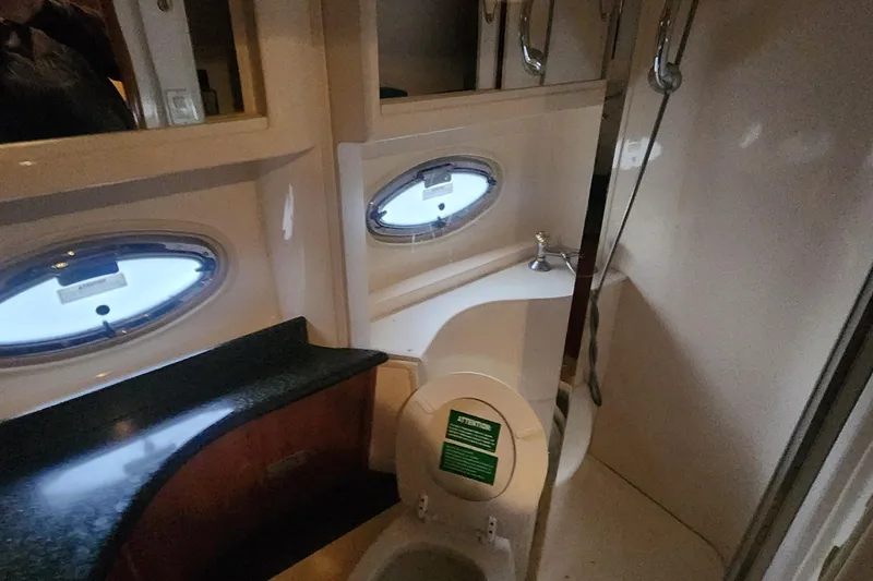 Slide: The Image of Bathroom interior of 2005 Carver 466 Motor Yacht with porthole window and modern fixtures. - 23