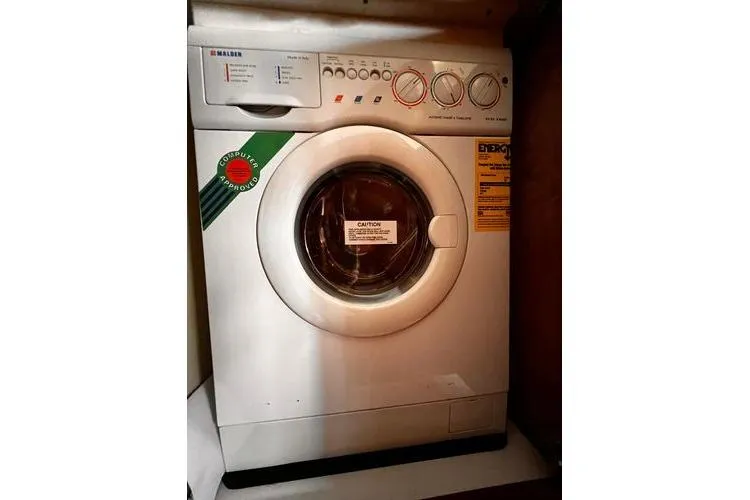 Slide: The Image of Front-loading washing machine inside 2005 Carver 466 Motor Yacht laundry area. - 28