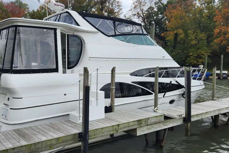 Slide: The Image of 2005 Carver 466 Motor Yacht docked by autumn trees. - 32