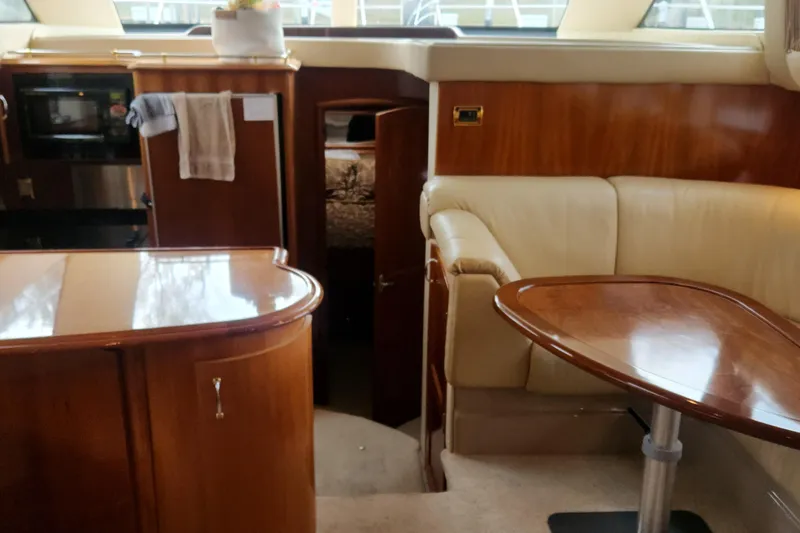 Slide: The Image of Luxurious interior of 2005 Carver 466 Motor Yacht with wood finishes and leather seating. - 13