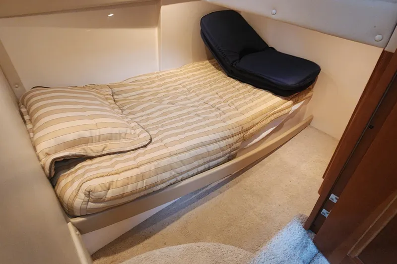Slide: The Image of Cozy cabin bed in 2005 Carver 466 Motor Yacht with striped bedding. - 16