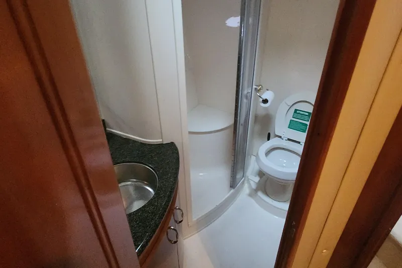Slide: The Image of 2005 Carver 466 Motor Yacht bathroom with sink, toilet, and shower. - 18