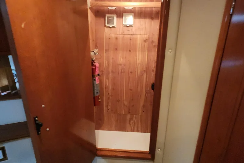 Slide: The Image of Interior of 2005 Carver 466 Motor Yacht with wooden paneling and fire extinguisher. - 19