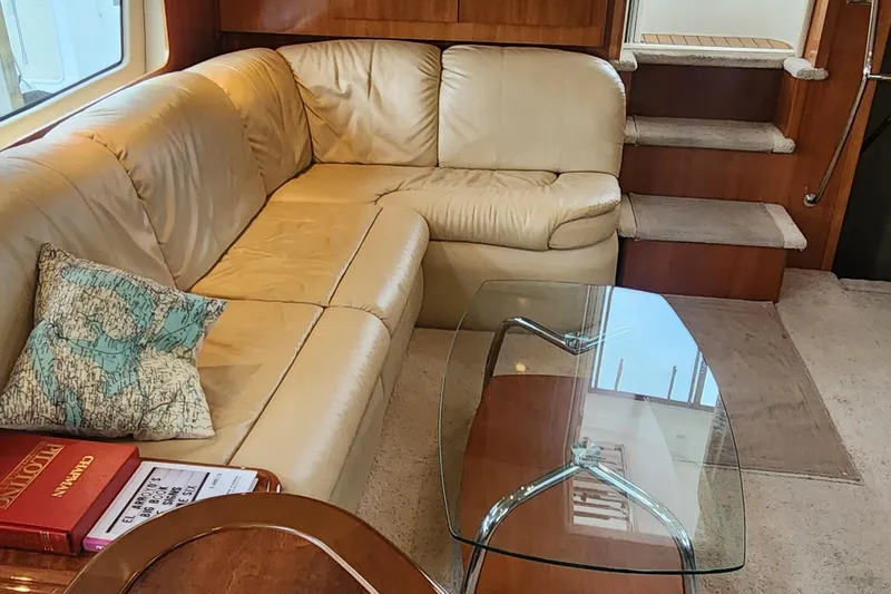Slide: The Image of Luxurious interior of 2005 Carver 466 Motor Yacht with leather seating and glass table. - 27