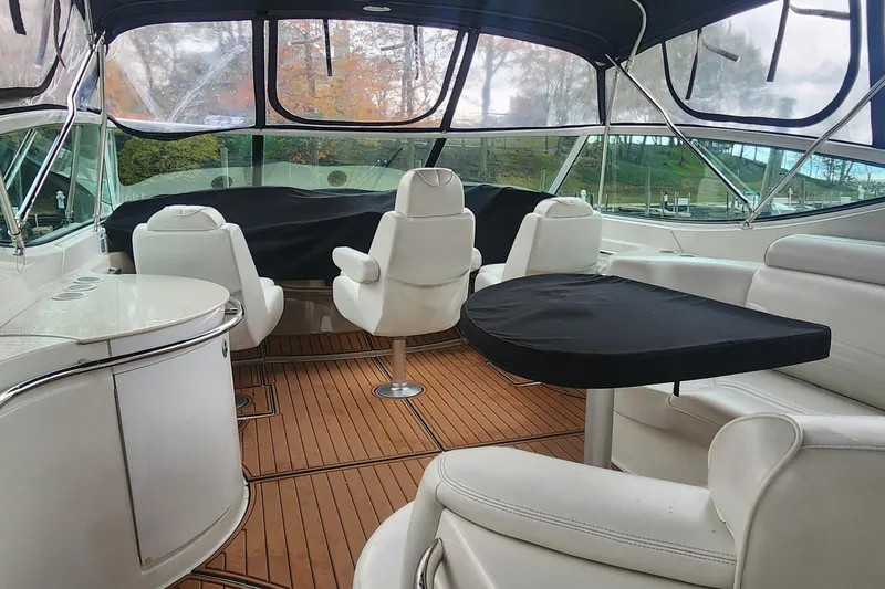 Slide: The Image of 2005 Carver 466 Motor Yacht interior with white seating and wooden flooring. - 30