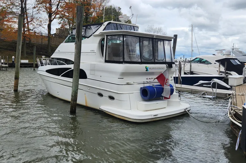 Slide: The Image of 2005 Carver 466 Motor Yacht docked at marina with autumn trees in background. - 34