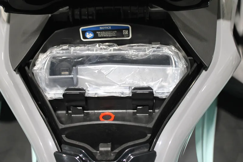 Slide: The Image of 2023 Sea-Doo Wake Pro 230 glove box interior with protective cover. - 10