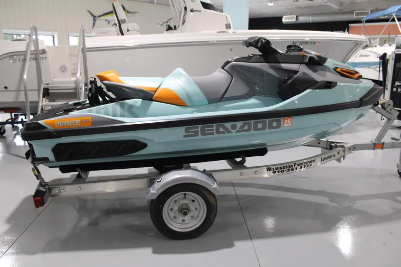 Slide: The Image of 2023 Sea-Doo Wake Pro 230 jet ski on trailer in showroom. - 2
