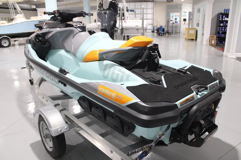 Slide: The Image of 2023 Sea-Doo Wake Pro 230 jet ski on trailer in showroom setting. - 3