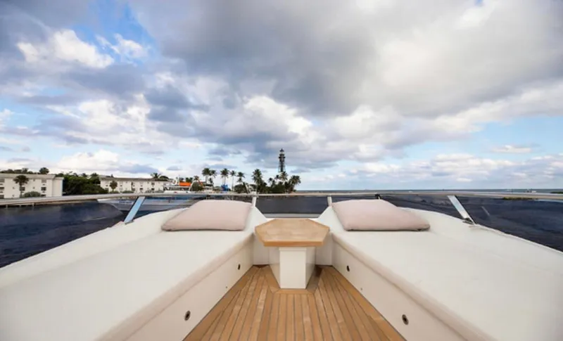 Slide: The Image of Luxurious 2019 Numarine 78 yacht deck with cushions, ocean view, and cloudy sky. - 10