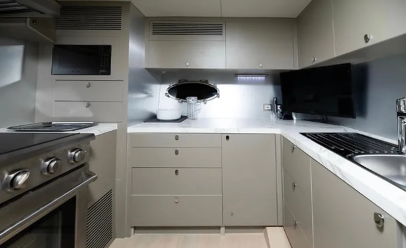Slide: The Image of Modern kitchen interior on 2019 Numarine 78 yacht, featuring sleek cabinetry and stainless steel appliances. - 23