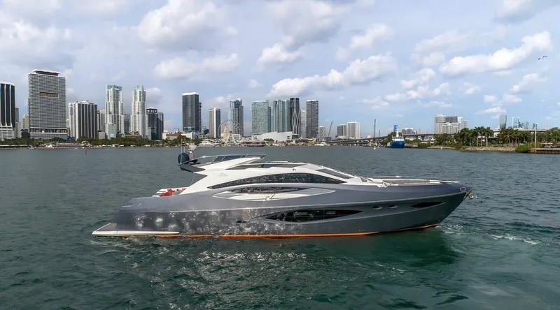 Slide: The Image of 2019 Numarine 78 yacht cruising near a city skyline under a partly cloudy sky. - 3