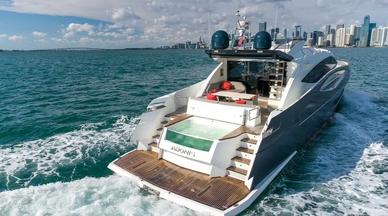 Slide: The Image of Luxurious 2019 Numarine 78 yacht cruising near a city skyline on a sunny day. - 5