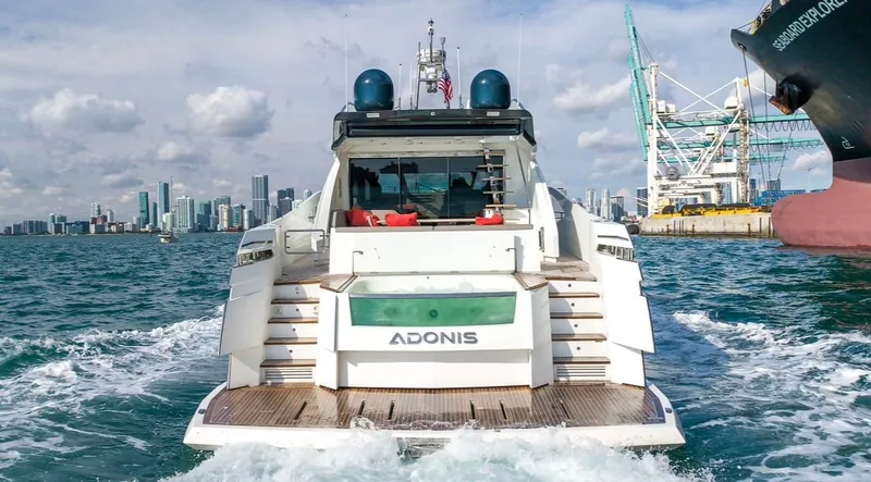 Slide: The Image of 2019 Numarine 78 yacht cruising near city skyline and industrial port. - 6