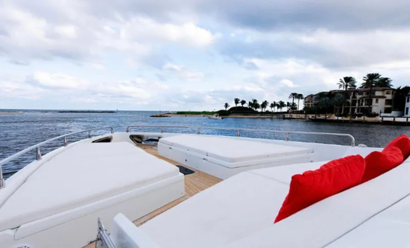Slide: The Image of Luxurious 2019 Numarine 78 yacht deck with white seating and red cushions, overlooking serene waters. - 8