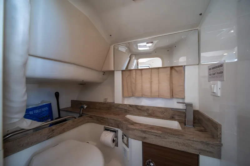 Slide: The Image of 2018 Formula 350 Crossover Bowrider OB bathroom with modern sink and mirror. - 12