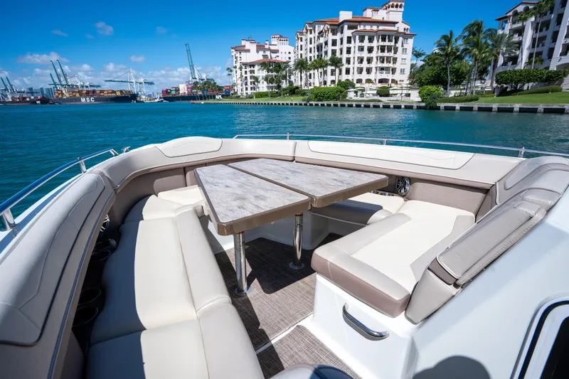 Slide: The Image of 2018 Formula 350 Crossover Bowrider OB with luxurious seating, docked near waterfront buildings. - 22