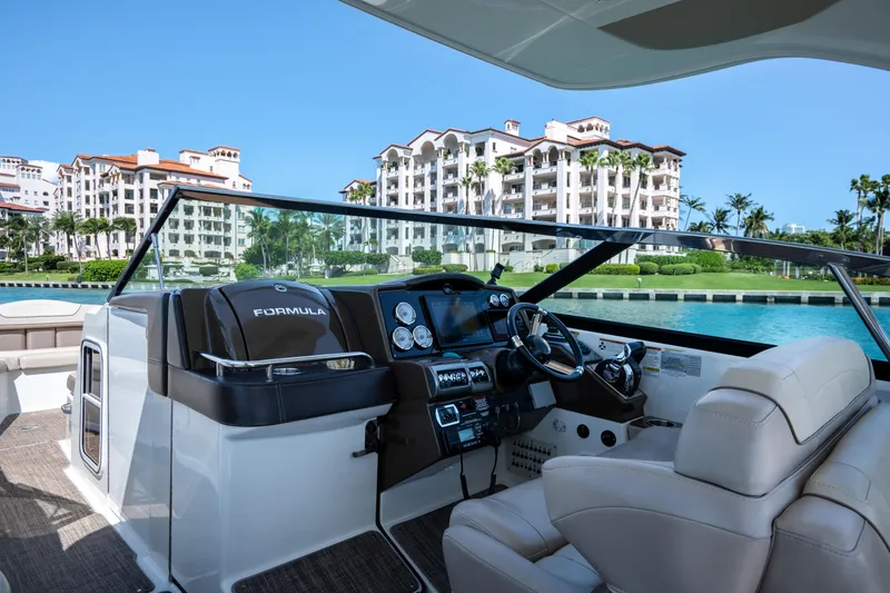 Slide: The Image of 2018 Formula 350 Crossover Bowrider OB interior with waterfront view and luxury buildings. - 29