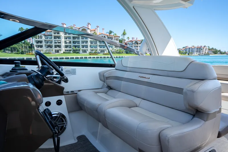 Slide: The Image of 2018 Formula 350 Crossover Bowrider OB interior with luxurious seating, overlooking waterfront buildings. - 33