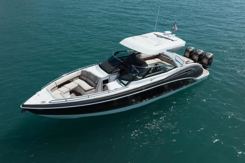 Slide: The Image of 2018 Formula 350 Crossover Bowrider OB on clear blue water, showcasing sleek design and powerful engines. - 4