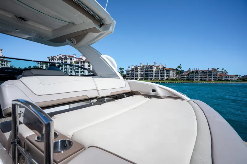 Slide: The Image of 2018 Formula 350 Crossover Bowrider OB on water, luxury seating, coastal buildings in background. - 41