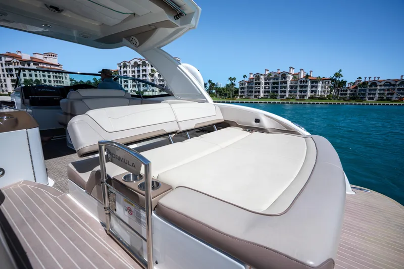 Slide: The Image of 2018 Formula 350 Crossover Bowrider OB on water, luxury seating, waterfront buildings in background. - 42