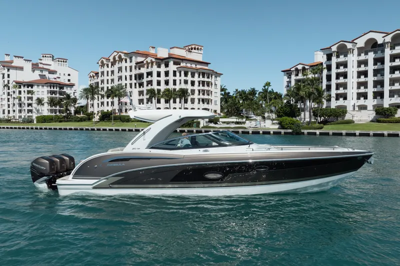 Slide: The Image of 2018 Formula 350 Crossover Bowrider OB cruising near luxury waterfront buildings. - 7