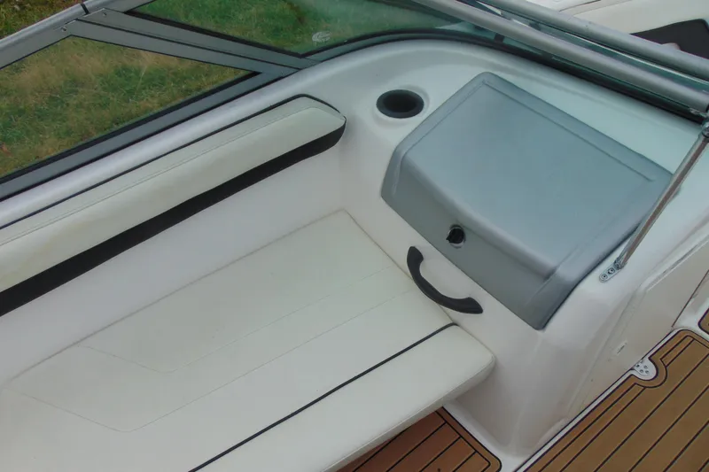 Slide: The Image of Interior of 2015 Yamaha AR190 boat with white seating and storage compartment. - 11