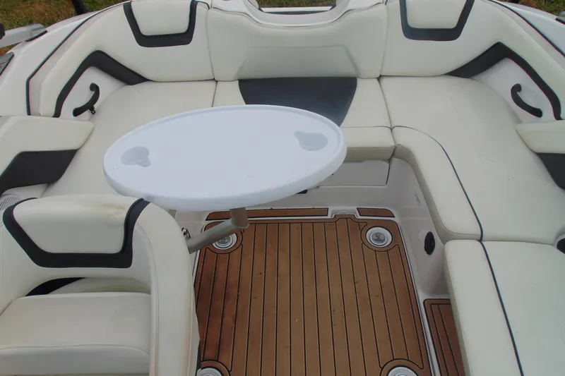 Slide: The Image of 2015 Yamaha Boats AR190 interior with white seating and wooden deck. - 9