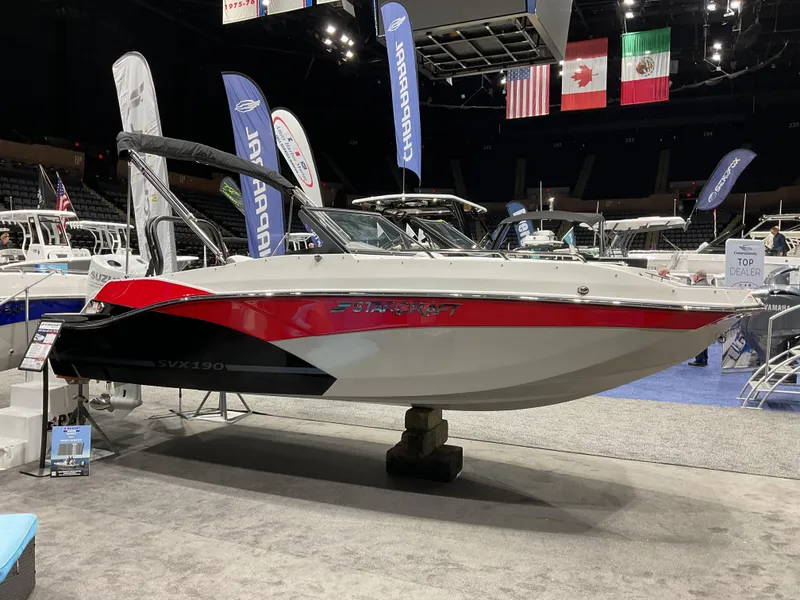 The Image of 2024 Starcraft SVX 190 OB DC boat on display at an indoor boat show. - 0