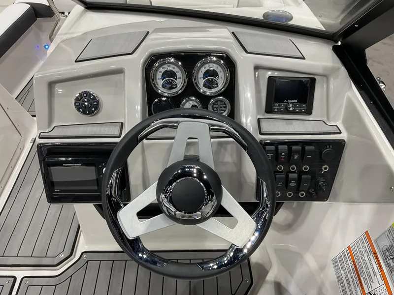 Slide: The Image of 2024 Starcraft SVX 190 OB DC boat dashboard with steering wheel and control panel. - 5