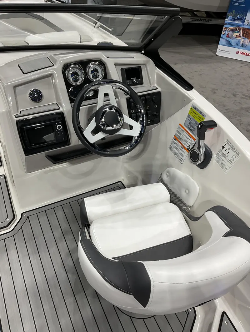 Slide: The Image of 2024 Starcraft SVX 190 OB DC boat cockpit with steering wheel and control panel. - 8