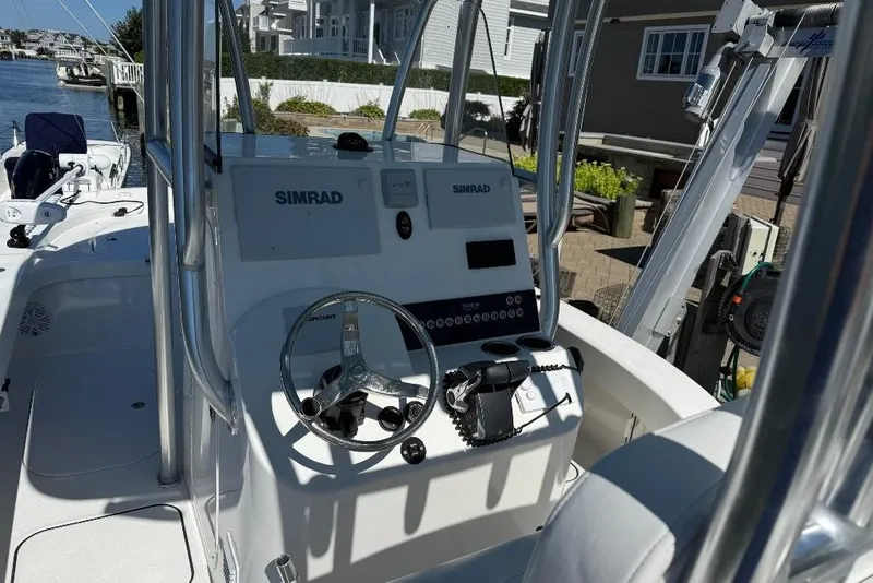 Slide: The Image of 2025 Tideline 235 Hybrid boat cockpit with Simrad navigation system and steering wheel. - 10