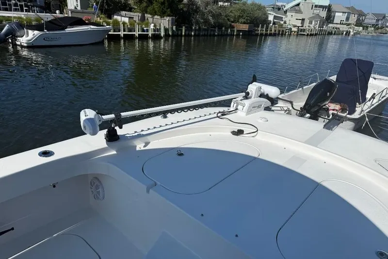 Slide: The Image of 2025 Tideline 235 Hybrid boat docked in a scenic waterfront area. - 13