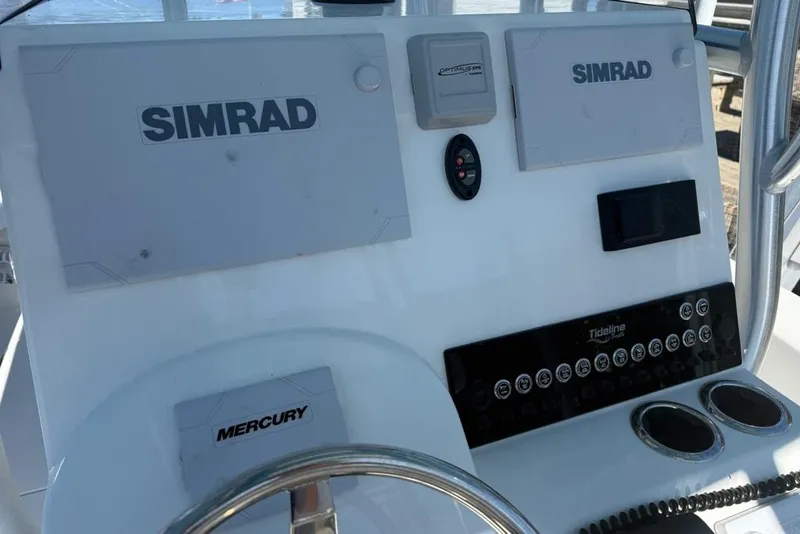 Slide: The Image of 2025 Tideline 235 Hybrid boat dashboard with Simrad and Mercury controls. - 17