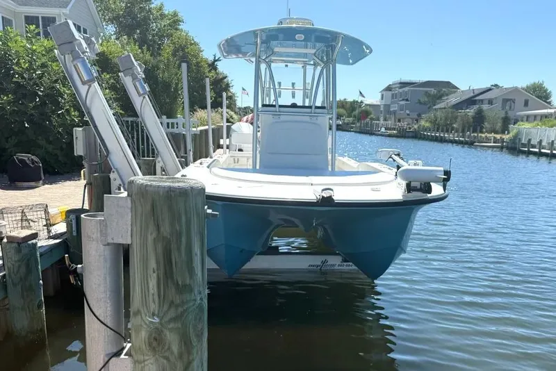 Slide: The Image of 2025 Tideline 235 Hybrid boat docked in a sunny waterfront setting. - 2