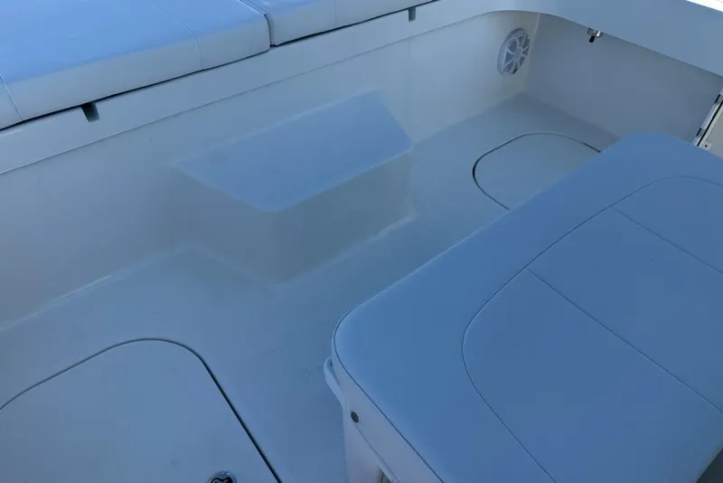 Slide: The Image of Interior of 2025 Tideline 235 Hybrid boat, featuring cushioned seating and storage compartments. - 21
