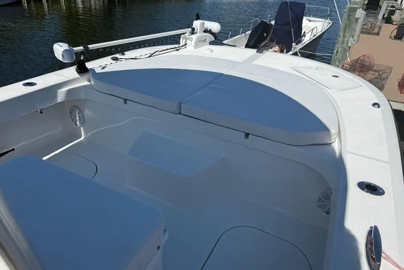 Slide: The Image of 2025 Tideline 235 Hybrid boat interior with cushioned seating and fishing rod holders. - 22