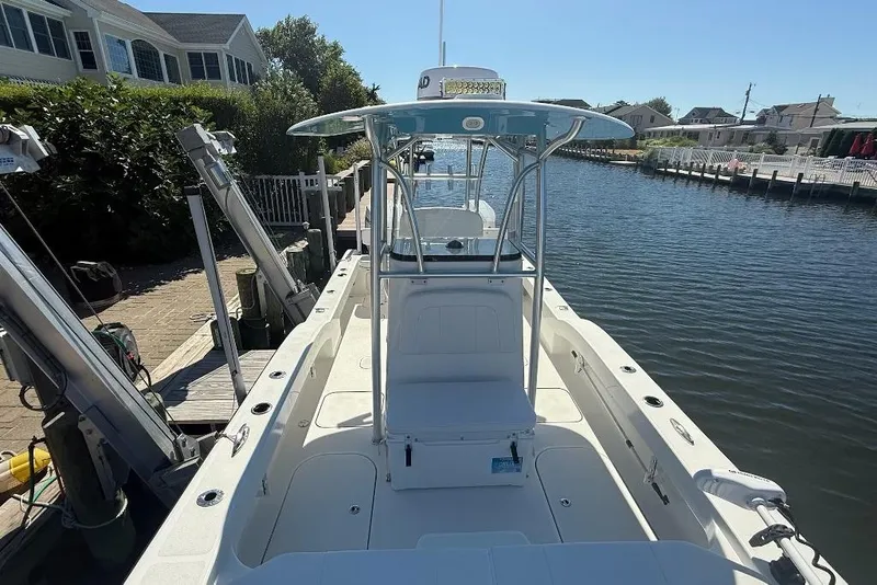 Slide: The Image of 2025 Tideline 235 Hybrid boat docked by a scenic waterfront. - 26