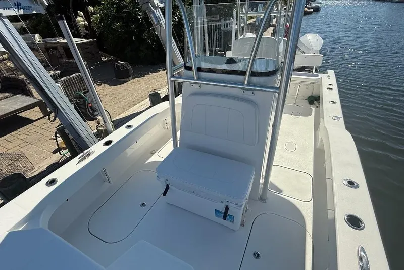 Slide: The Image of 2025 Tideline 235 Hybrid boat interior, featuring spacious deck and seating by the water. - 27