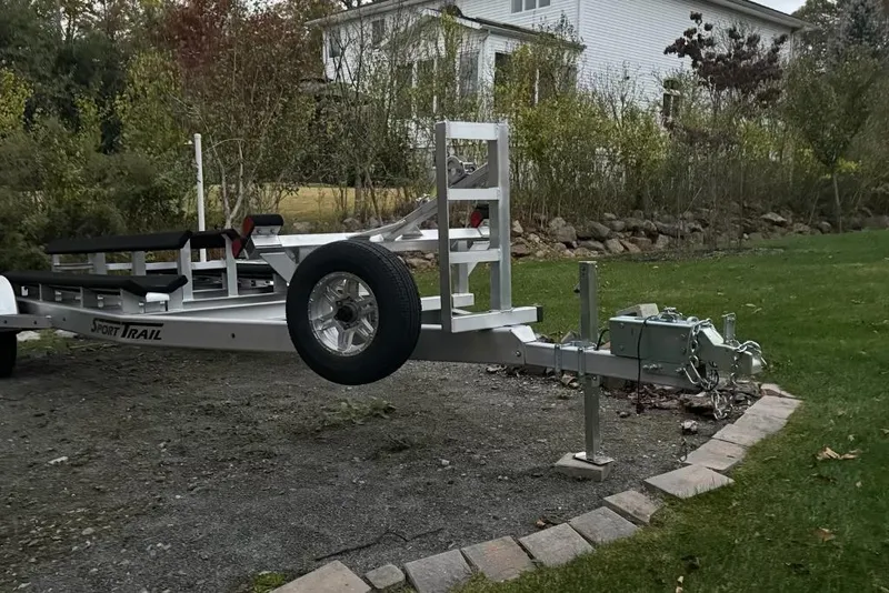 Slide: The Image of Trailer for 2025 Tideline 235 Hybrid boat parked on gravel driveway. - 31