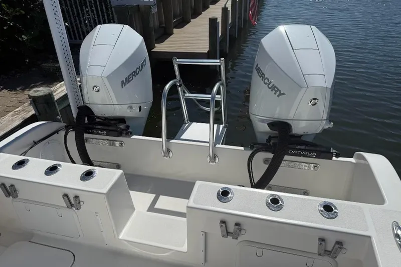 Slide: The Image of 2025 Tideline 235 Hybrid boat with dual Mercury outboard engines docked by the water. - 8