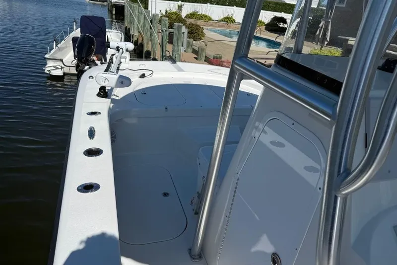 Slide: The Image of 2025 Tideline 235 Hybrid boat docked, showcasing sleek design and spacious deck. - 9