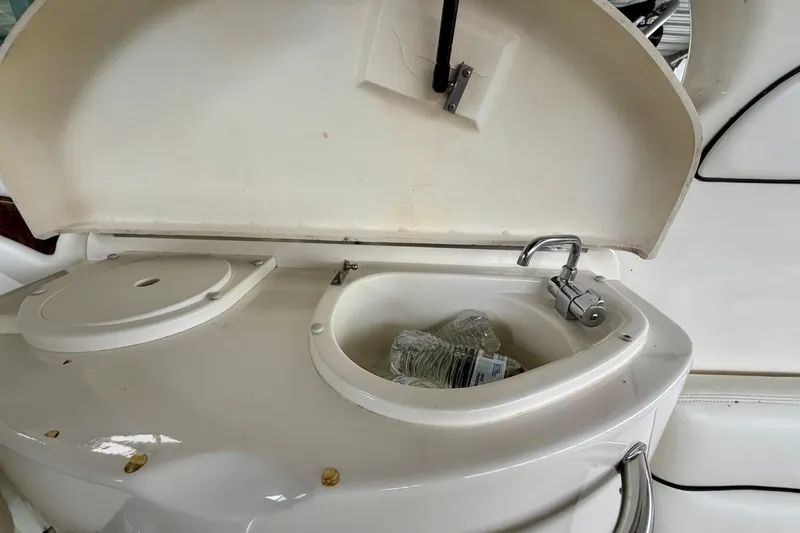 Slide: The Image of 2007 Sea Ray 290 SLX boat interior with steering wheel and white captain's chair. - 13