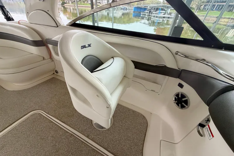 Slide: The Image of 2007 Sea Ray 290 SLX boat interior with curved seating and scenic lake view. - 15