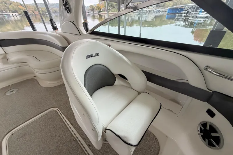 Slide: The Image of 2007 Sea Ray 290 SLX boat interior with curved seating and lake view. - 16