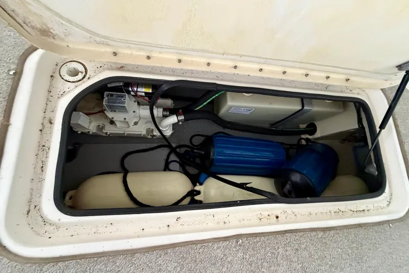 Slide: The Image of Polk Audio speaker on 2007 Sea Ray 290 SLX boat, docked under a covered area. - 25