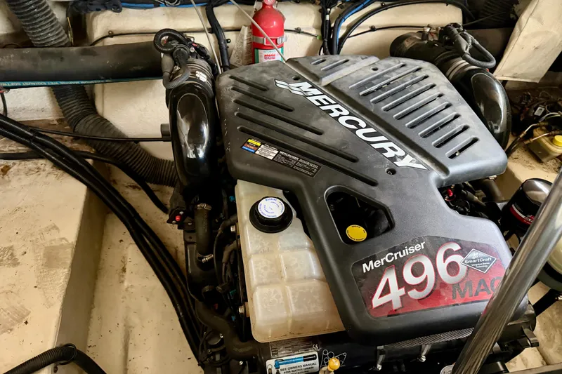 Slide: The Image of Open storage compartment in 2007 Sea Ray 290 SLX boat, containing equipment and fenders. - 31